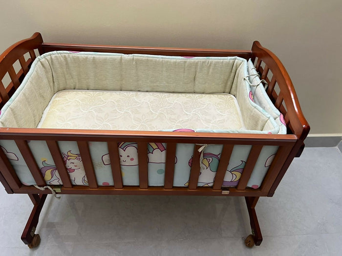 BABYHUG cradle with BABYHUG mattress and bumpers featuring cozy sleeping space, cushioned mattress, protective side bumpers, sturdy frame, and comfortable support for baby sleep.