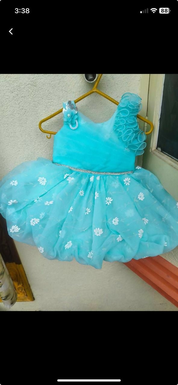 Turquoise children's dress with floral details