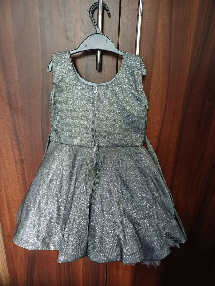 Elevate your baby girl's look with our Silver Frock/Dress, offering timeless charm and elegance for special occasions.