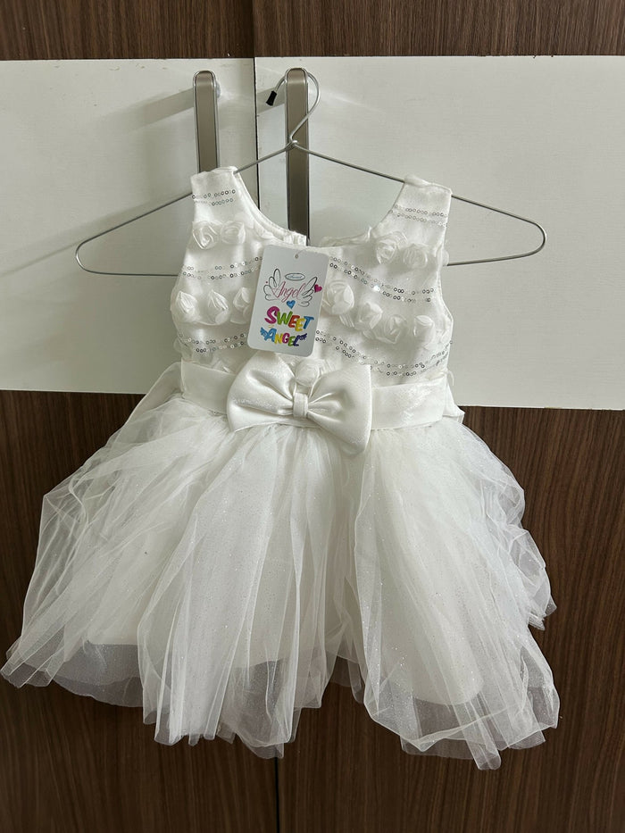 White children's dress with a bow