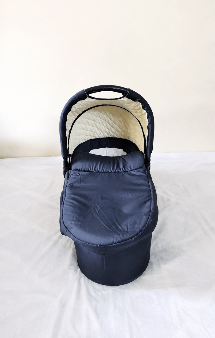 babycab Noah Carrycot Bassinet in Navy Blue, designed as a stroller attachment with a comfortable padded interior, protective canopy, sturdy construction, and cozy lie-flat space for newborns and young infants.