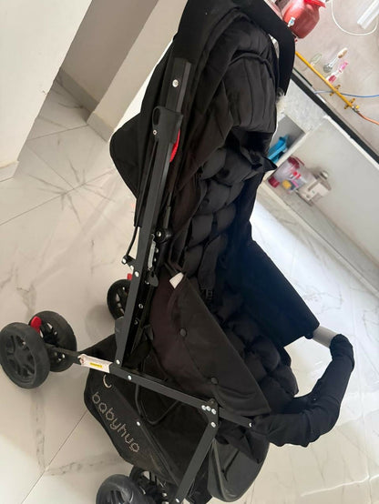 BABYHUG Cocoon stroller/pram with a reclining seat, foldable dacesign, adjustable canopy, 5-point safety harness, smooth wheels, and storage basket for comfortable travel with babies and toddlers.