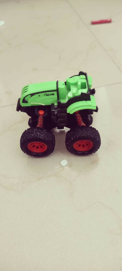 Toy car with green body and black wheels on a light-colored floor.