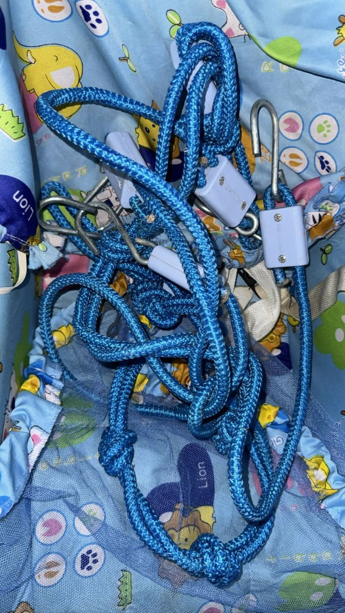 Blue rope with carabiners on a colorful fabric background