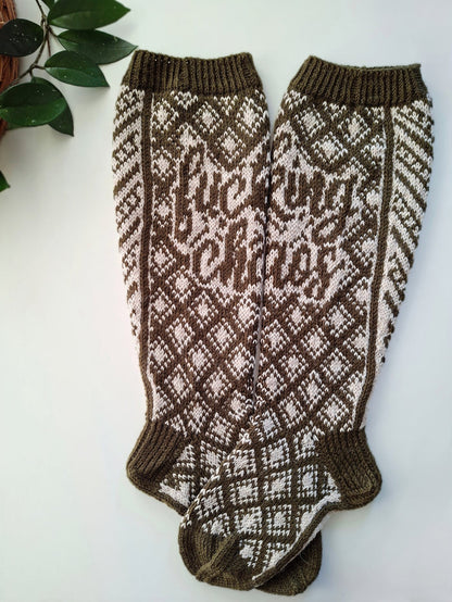 Pair of brown and white patterned socks with the text Fucking Chaos on a light background