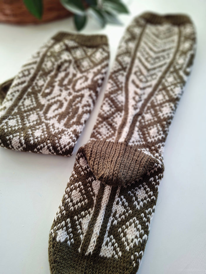 Pair of brown and white patterned socks on a light background