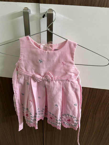 Pink children's dress with floral patterns