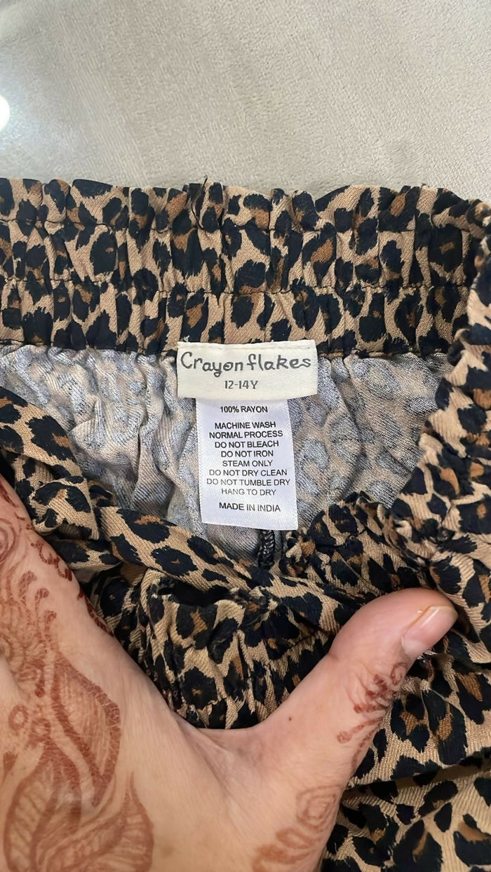 Leopard print fabric with a label on a neutral background