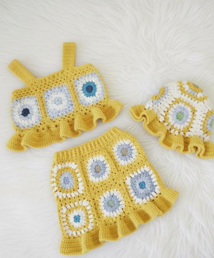 Crocheted outfit with a dress, top, and hat