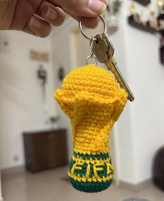 Handcrafted crochet FIFA World Cup-inspired keychain made from soft yarn, featuring a miniature football-themed design with durable key ring attachment, perfect for football fans, gifting, and everyday use.