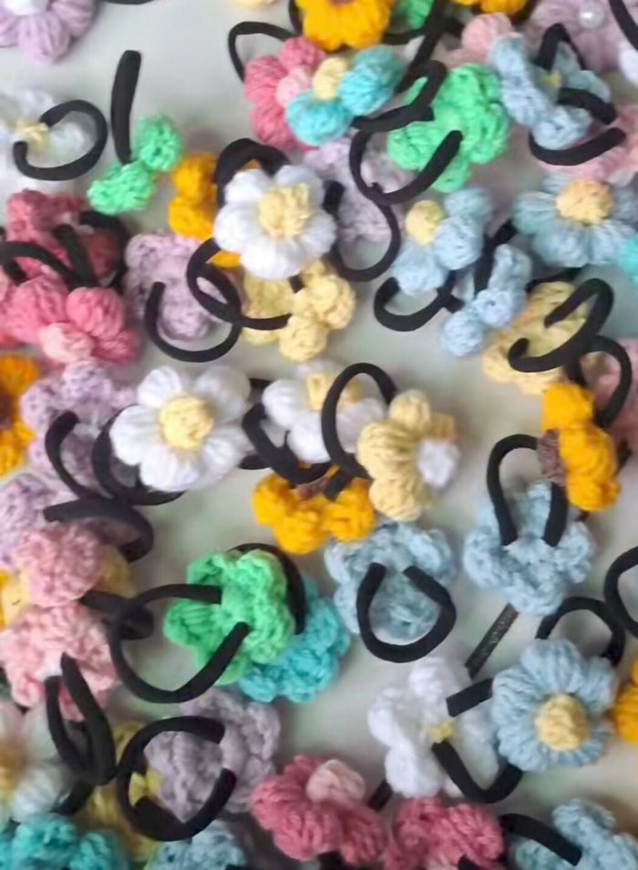 Colorful hair ties with floral designs on a white background