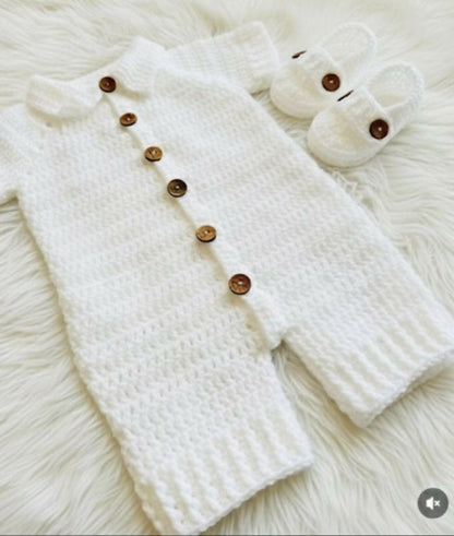 White knitted baby outfit with wooden buttons