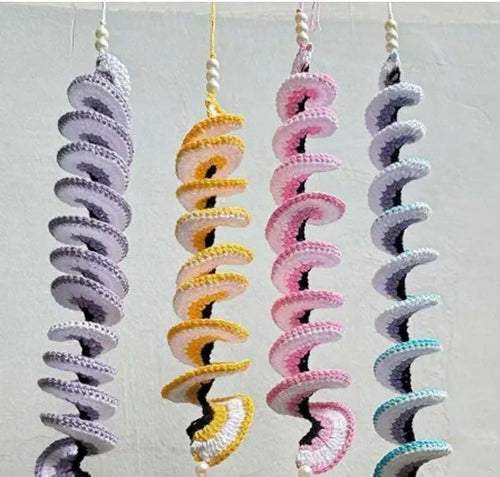 Set of colorful spiral dog toys on a light gray background