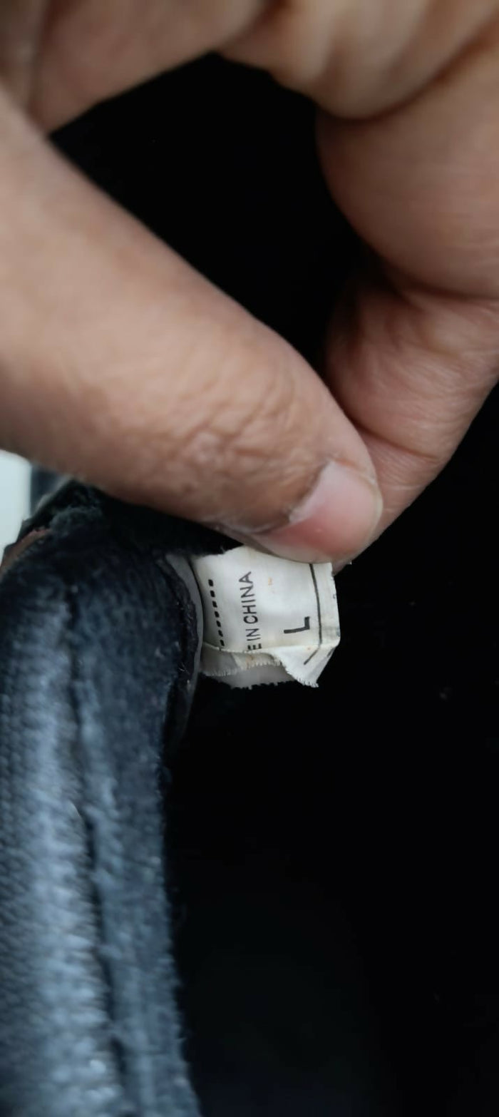 Close-up of a clothing tag on fabric with a blurred background