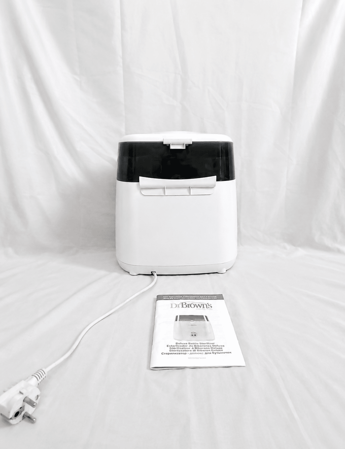 Dr. Brown's Deluxe electric steam bottle sterilizer with BPA-free construction, 6-bottle capacity, and spacious compartments for bottles, nipples, pacifiers, and baby feeding accessories.