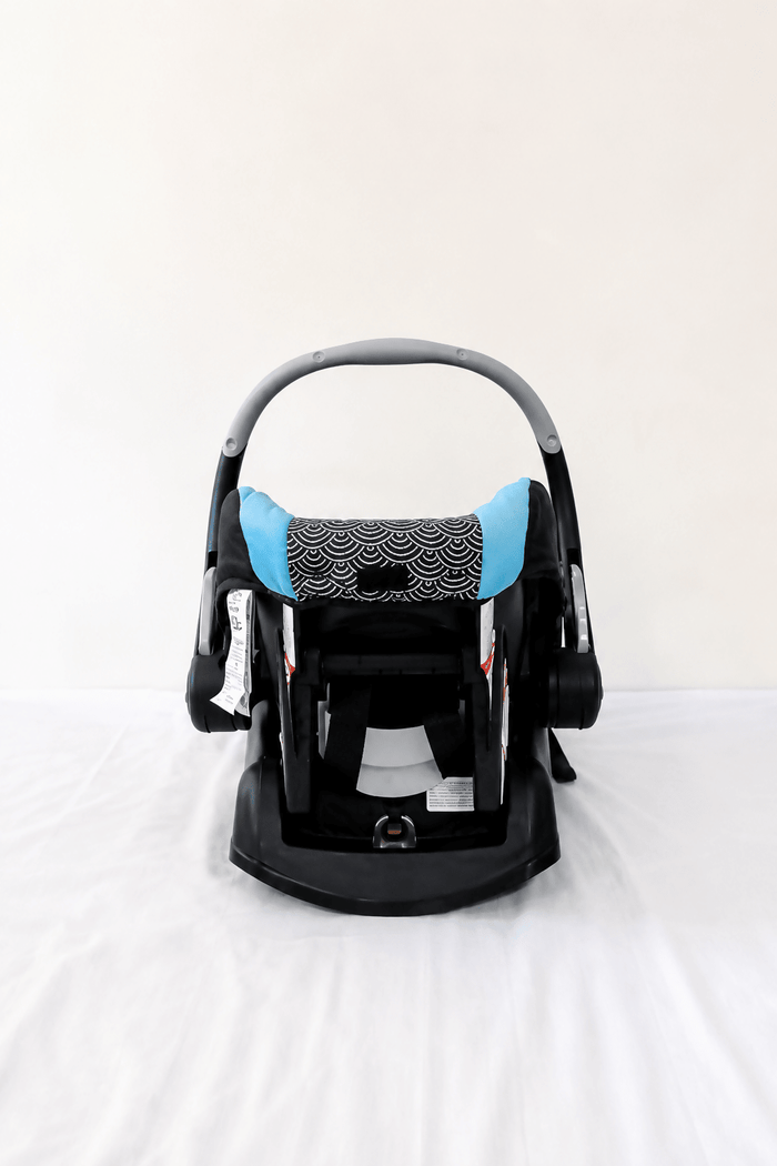 Evenflo Embrace infant car seat with base, rear-facing design, cushioned newborn support, secure safety harness, and portable baby carrier functionality for safe travel.