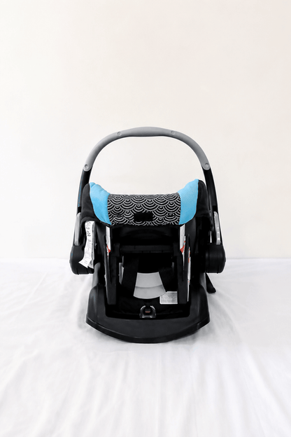 Evenflo Embrace infant car seat with base, rear-facing design, cushioned newborn support, secure safety harness, and portable baby carrier functionality for safe travel.