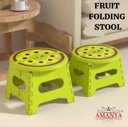 Two green folding stools
