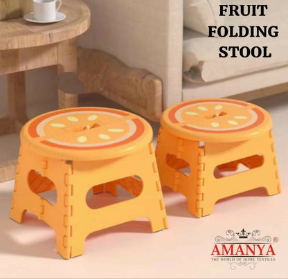 Two orange folding stools with fruit design