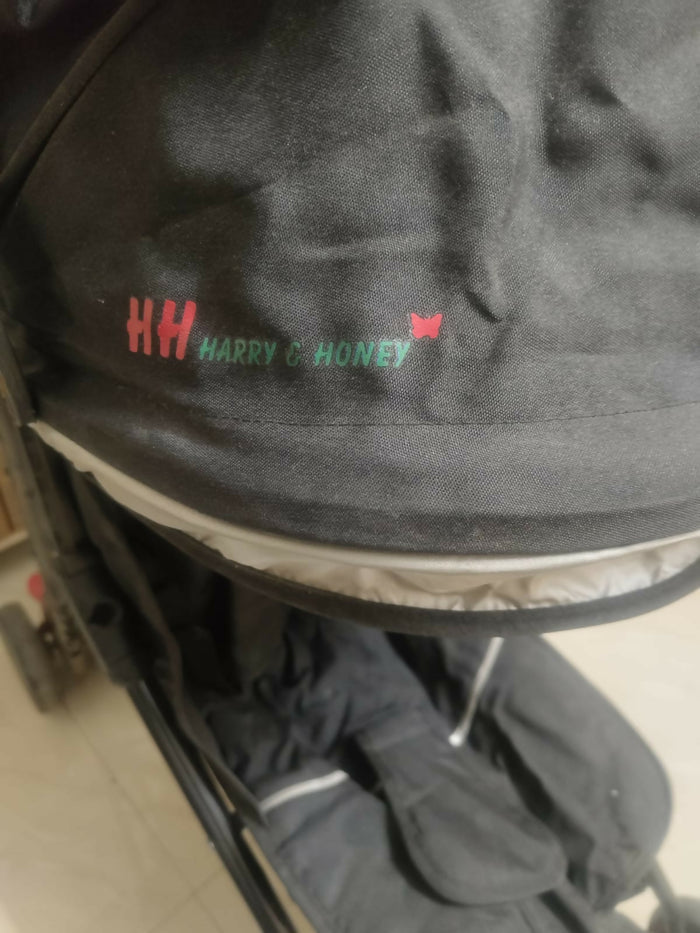 HARRY AND HONEY baby stroller/pram with a lightweight foldable design, reclining seat, adjustable canopy, 5-point safety harness, smooth wheels, and spacious storage basket for comfortable travel with babies and toddlers.