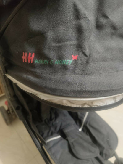 HARRY AND HONEY baby stroller/pram with a lightweight foldable design, reclining seat, adjustable canopy, 5-point safety harness, smooth wheels, and spacious storage basket for comfortable travel with babies and toddlers.
