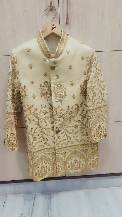 Embroidered traditional outfit on a hanger against a light background