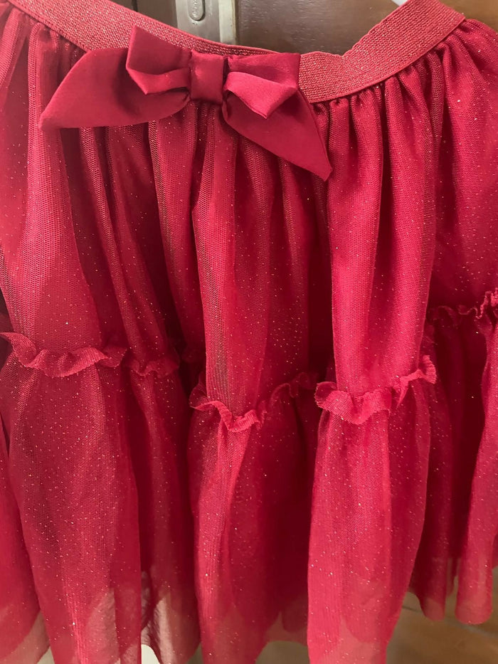 Red dress with a bow detail on a plain background