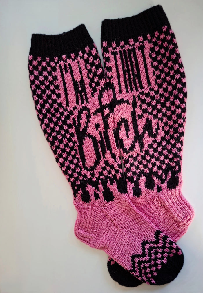 Pink and black patterned socks with the text "I'm that bitch" on a white background