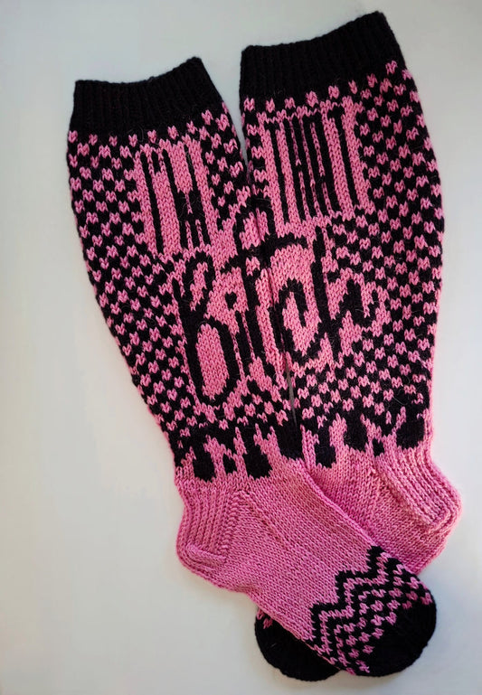 Pink and black patterned socks with the text "I'm that bitch" on a white background