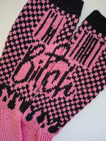 Pink and black patterned socks with the text "I'm that bitch" on a white background