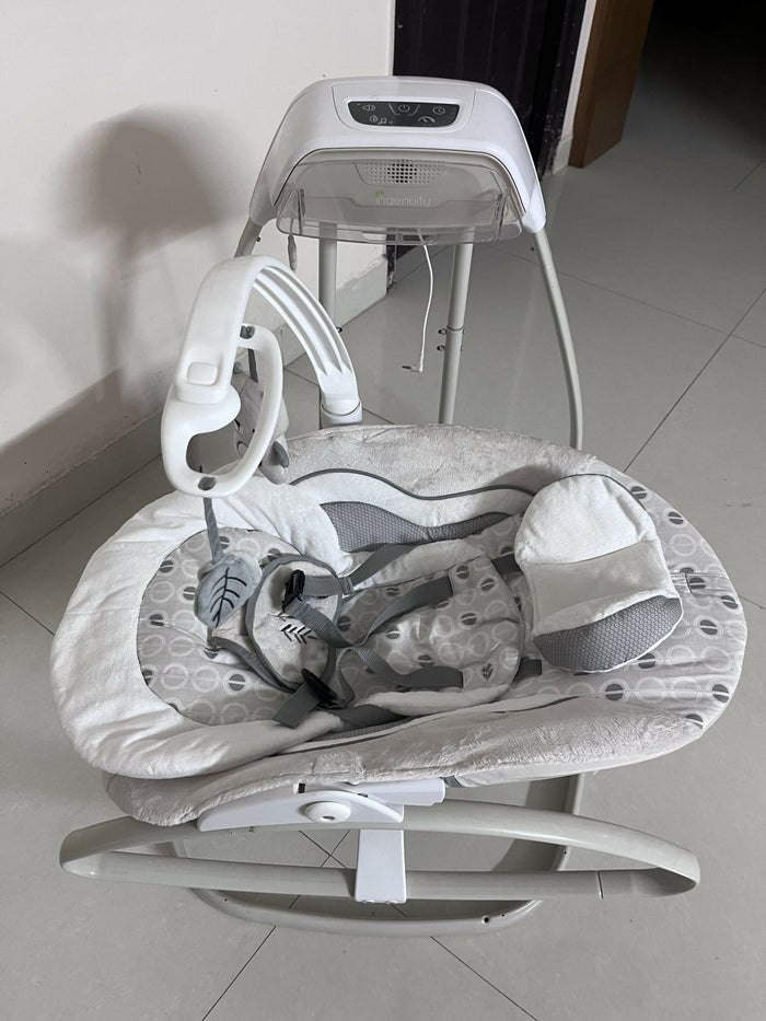 INGENUITY gliding swing and rocker with gentle gliding motion, cushioned seat, safety harness, and soothing design for relaxing, comforting, and entertaining babies.