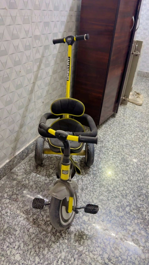 Jam & Honey Baby Tricycle in Almost New condition featuring a sturdy frame, comfortable seat, easy-grip handlebars, smooth wheels, and child-friendly design for fun riding and active outdoor play.