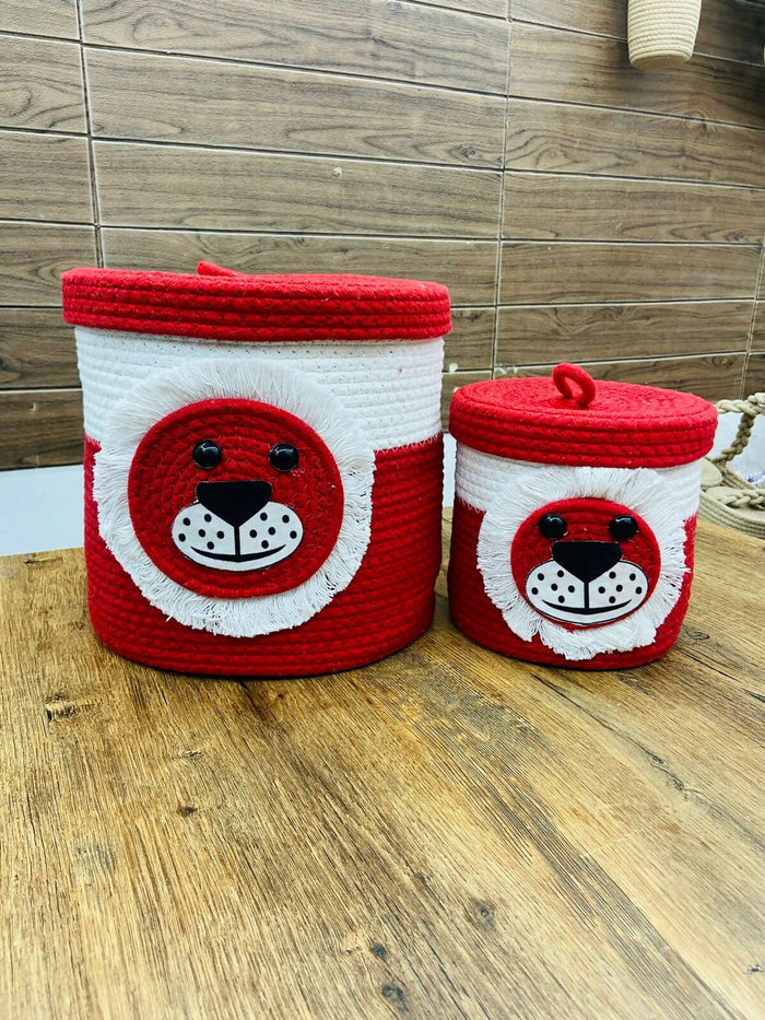 Two red and white woven storage baskets with animal face designs