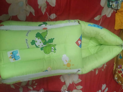 LUVLAP 3-in-1 Soft Cotton Baby Carry Nest in Dino Print, Almost New condition, featuring soft cotton fabric, cushioned bedding, and a cozy portable design for carrying, resting, and supervised lounging.