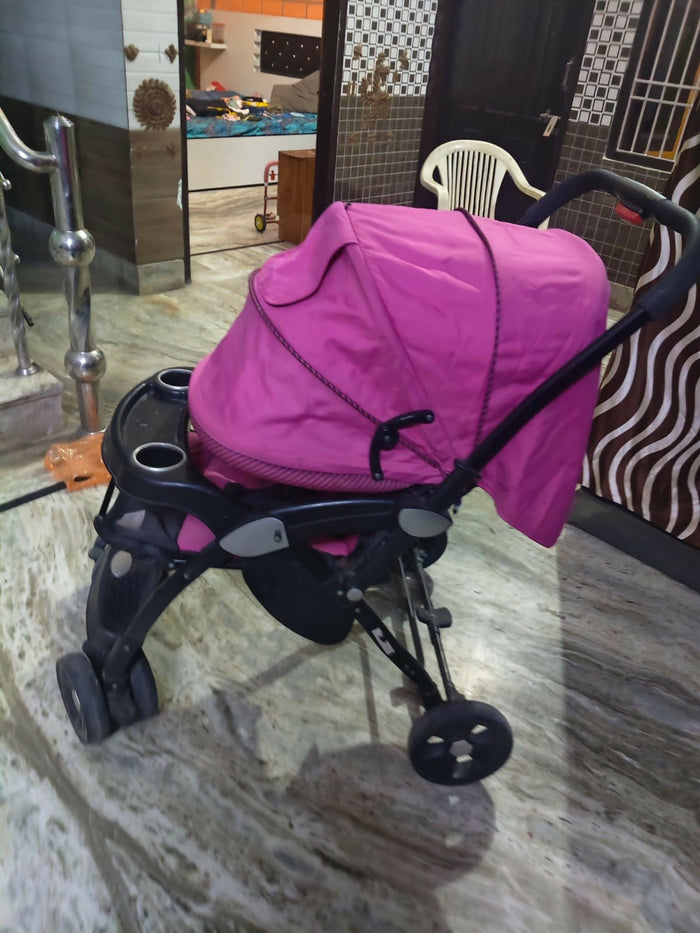 LUVLAP Galaxy stroller in pink with reclining seat, smooth wheels, safety harness, adjustable canopy, and comfortable travel design for babies and toddlers.