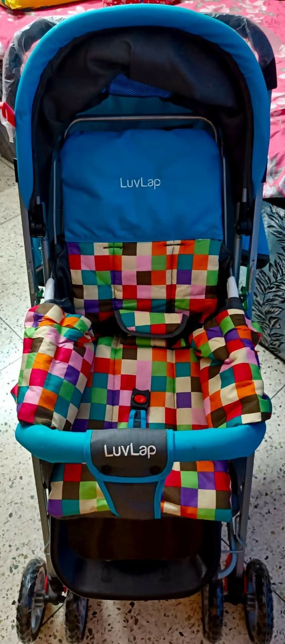 A blue LuvLap stroller with a colorful patchwork-patterned seat cushion