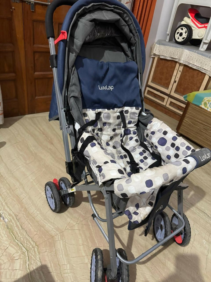 Stroller with a patterned cover on a wooden floor