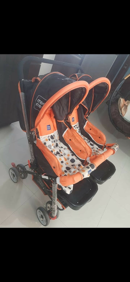 Mee Mee twin stroller pram for babies with dual seating, safety harnesses, smooth wheels, adjustable canopies, and comfortable design for outings with two children.
