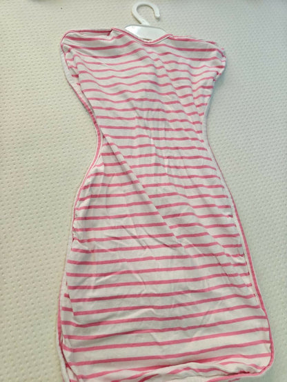 Striped dress with red and white pattern on a beige surface