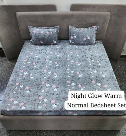 Gray star-patterned bedsheet set on a bed with pillows