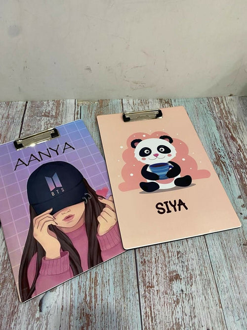 Two clipboards with personalized designs on a wooden surface