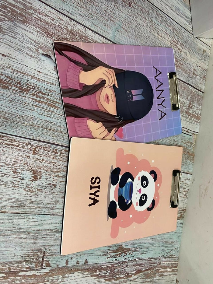 Two notebooks with different designs on a wooden surface