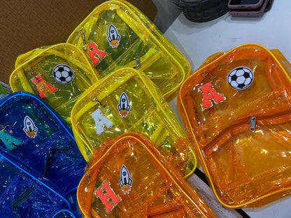 Colorful transparent bags with various designs on a white surface