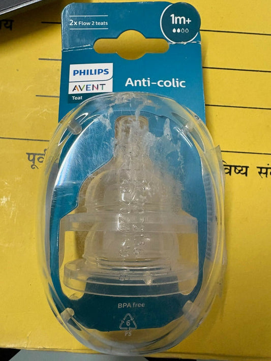 Philips Avent anti-colic baby bottle nipple on a yellow background