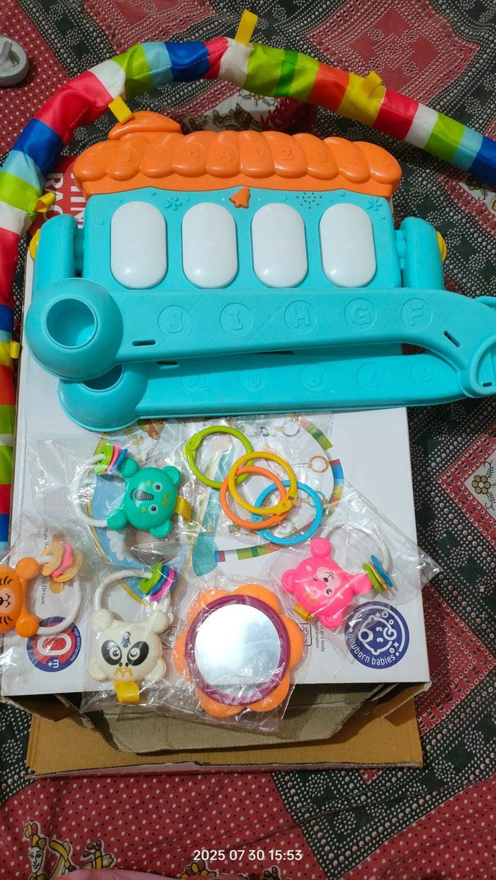Colorful baby toy set with a bus-shaped rattle and plastic rings