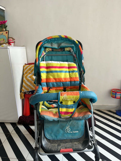 R for Rabbit Lollipop Lite baby stroller/pram with a lightweight foldable design, reclining seat, adjustable canopy, 5-point safety harness, smooth wheels, and storage basket for comfortable travel with babies and toddlers.