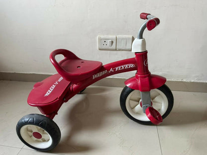 RADIO FLYER tricycle with sturdy construction, comfortable seat, easy-grip handlebars, smooth wheels, and child-friendly design for outdoor play and riding adventures.