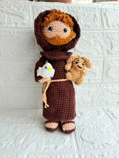 Handmade St. Francis of Assisi crochet doll crafted from soft yarn with detailed stitching, a gentle expression, and a charming design for gifting, collecting, or nursery décor.