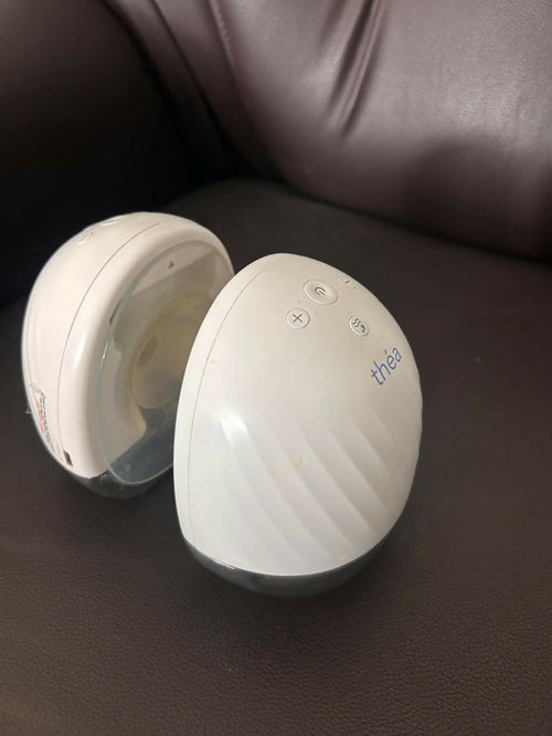 Théa wearable electric breast pump with hands-free design, compact milk collection cups, adjustable suction, and portable pumping support for breastfeeding mothers.