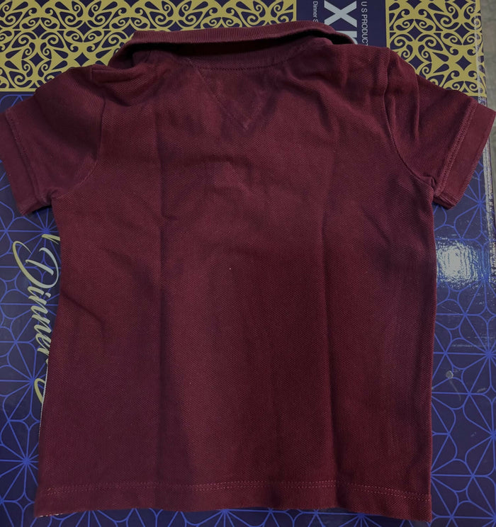 TOMMY HILFIGER maroon polo neck T-shirt featuring soft comfortable fabric, classic polo collar, short sleeves, and a smart casual look for everyday wear and outings.